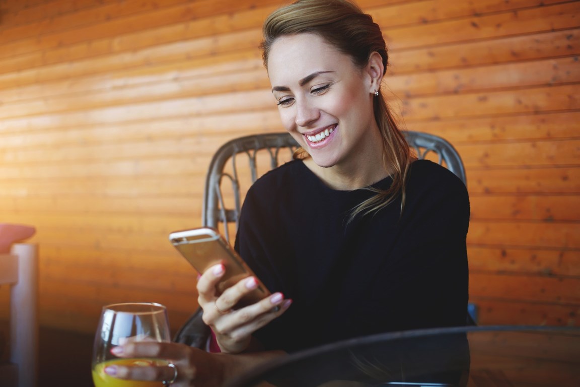 woman smiling at phone